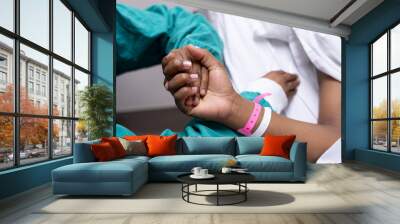 An image of a doctor holding a patients hand. Wall mural