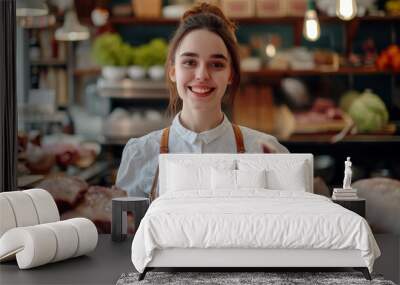 Female butcher happily advertising top-quality sausages and steaks Wall mural