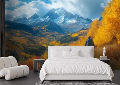 Hiker walking on a trail in a mountainous autumn landscape
 Wall mural