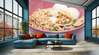 Instant noodle food with eggs in a cup on white background Wall mural