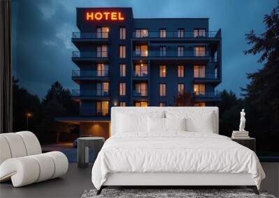 Modern hotel building illuminated during twilight with glowing sign and calm atmosphere in a serene location Wall mural