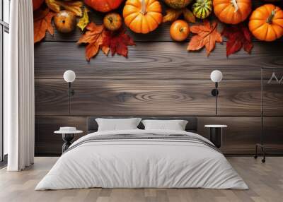 pumpkins and fallen leaves on wooden background. Copy space for text. Halloween, Thanksgiving day or seasonal autumnal Wall mural