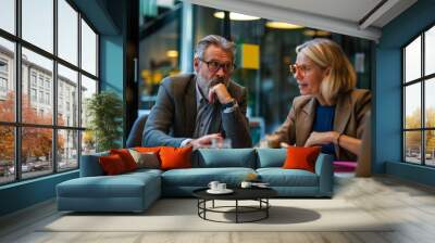 Two colleagues discussing business strategy at work professional collaboration concept Wall mural