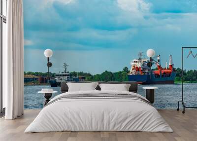 Blue cargo ship underway Wall mural