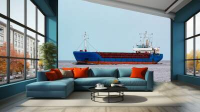 Blue cargo ship underway Wall mural