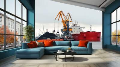 large red cargo ship loading with a coal in the port Wall mural