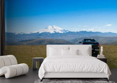 Pick up car at beautifull landscape view of Caucasus mountains near mount Elbrus - the highest mountain in Europe. Wall mural