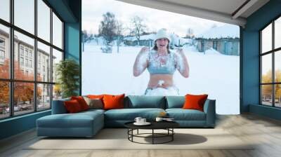 50 year old woman enjoying in swimsuit, in snow drifts. The concept of hardening, winter swimming happy healthy lifestyle Wall mural