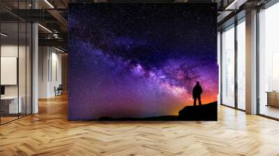 Beautiful starry night, man silhouette with a camera looking at the Milky Way galaxy. Wall mural