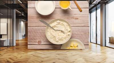 Baking cooking food ingredients, eggs, flour, butter, oil and milk. Top view, rustic wooden background Wall mural