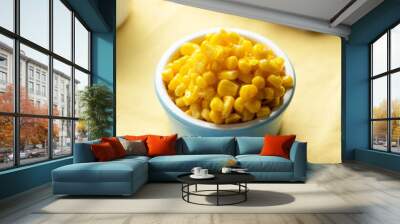 Bowl of sweet corn on blue background Wall mural