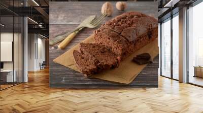 Piece of chocolate cake , fudge or pound cake. Wooden background. Wall mural