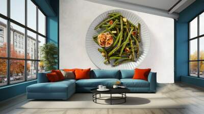 Roasted garlic green beans in grey plate. Top view. Wall mural