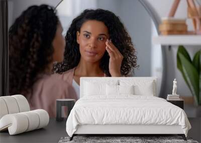 Beautiful mature American black woman looking at mirror at home Wall mural