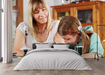 teenage girl and mother doing homework Wall mural