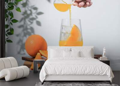 selective focus, pouring orange soda into glass on white background. soft drink is fresh summer drink in the morning, iced orange juice is alternative drinking for healthy living life Wall mural