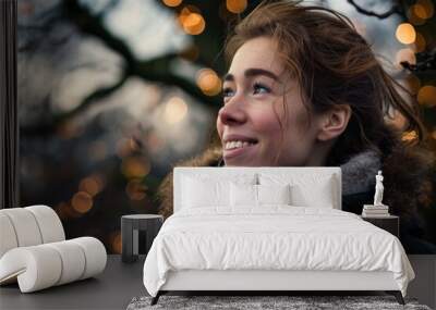 Portrait of a beautiful young woman in a winter park. Bokeh background. Wall mural