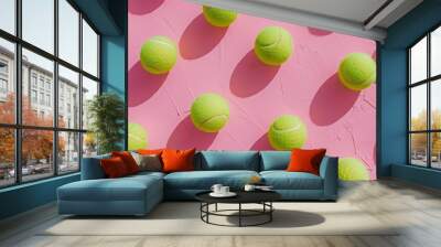 A collection of tennis balls on a pink background Wall mural