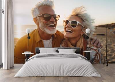 A portrait of an older couple with grey hair having fun and laughing on a beach Wall mural