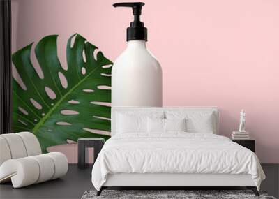 Blank white cosmetic bottle with a tropical leaf. 3D Render Wall mural