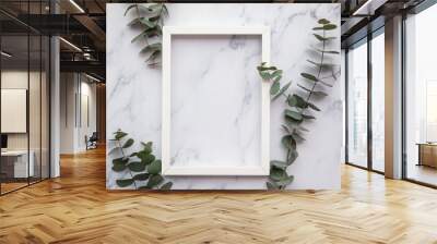 Blank white frame with eucalyptus leaves lay flat composition Wall mural