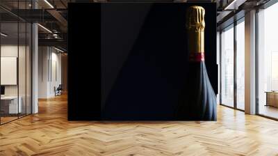 Champagne bottle on a black background with space for text Wall mural