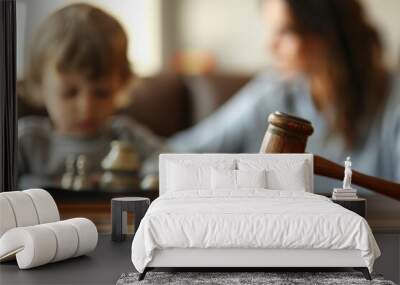 Close up of a legal judges hammer with a blurred child in the background. Child custody concept Wall mural