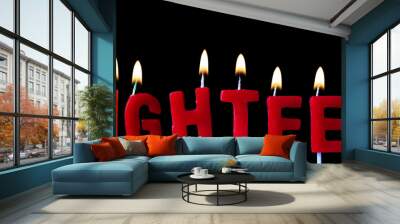 Eighteen spellt out in red birthday candles against a black background Wall mural