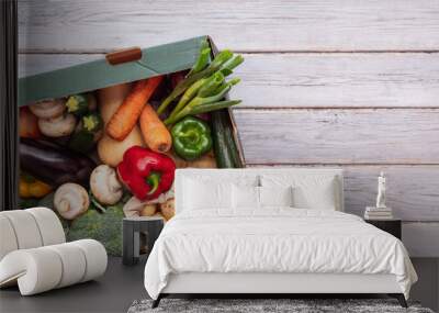 Fresh organic vegetable delivery box on a wooden background Wall mural