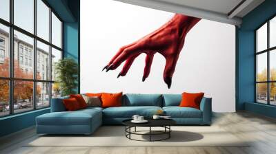 Halloween red devil monster hand with black fingernails against a plain background Wall mural