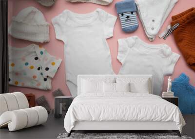 Newborn child clothing layout on a pastel pink background Wall mural