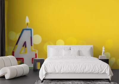 Number 4 birthday celebration candle against a bright lights and yellow background Wall mural