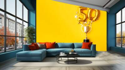 Number 50 gold anniversary celebration balloon exploding from a winning trophy Wall mural