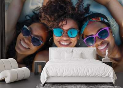 overhead view of a group of happy female friends relaxing on a beach together Wall mural