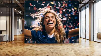 Portrait of a happy female football sport player celebrating winning with confetti falling Wall mural