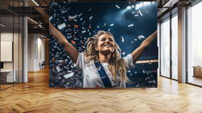 Portrait of a happy female football sport player celebrating winning with confetti falling Wall mural