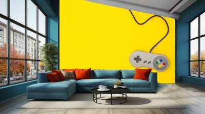 Retro computer gaming controller on a bright yellow background Wall mural