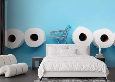 Roll of white toilet paper with a shopping cart on a blue background Wall mural