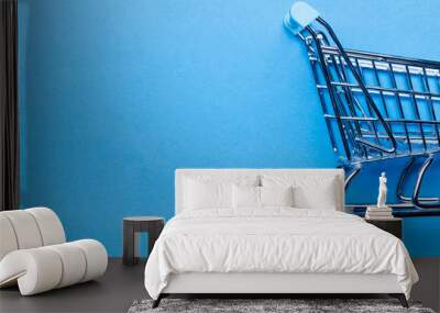 Shopping cart on a blue background Wall mural