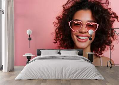 Studio portrait of a cool young woman posing wearing heart shaped love sunglasses Wall mural