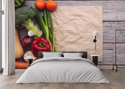 Top view of various fresh organic vegetables with a blank brown paper bag Wall mural