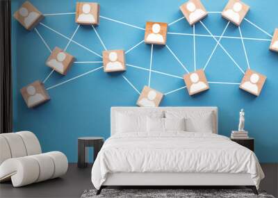 Wooden blocks connected together on a blue background. Teamwork concept Wall mural