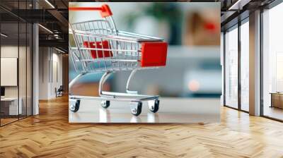 Miniature shopping cart on a blurred background. Perfect for e-commerce, marketing, retail, and business-related visuals. Wall mural