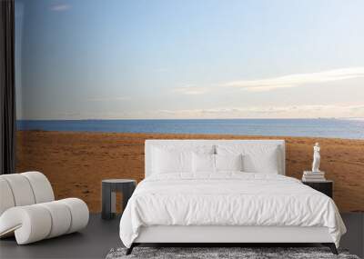 Deserted seascape. Minimalism. Strip of orange sand, sea and clear blue sky Wall mural