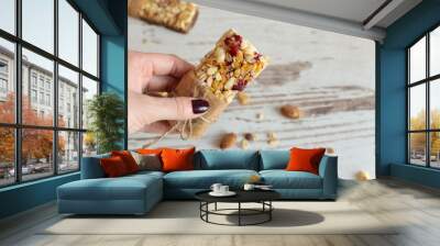 Cereal granola bar with nuts, fruit and berries on wooden table background. Healthy sweet dessert snack. Wall mural