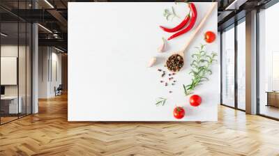 Composition of colorful pepper seeds, fresh chili pepper, tomatoes, garlic and rosemary herb top view on white wooden background. Italian herbs and spices. Wall mural