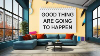 Good Things Are Going To Happen text on notepad on yellow table. Wall mural