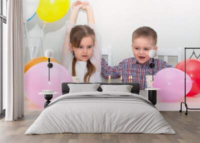 Happy kids girl and boy celebrate their birthday. Festive colorful background with balloons. Joy happiness positive mood Wall mural