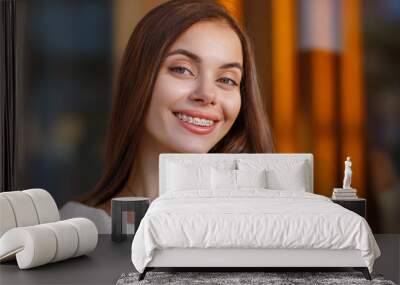 portrait of a beautiful happy smiling young woman with braces. girl bracket system  outdoor. Brace, bracket, dental care, malocclusion, orthodontic health concept. Blurred Details Wall mural