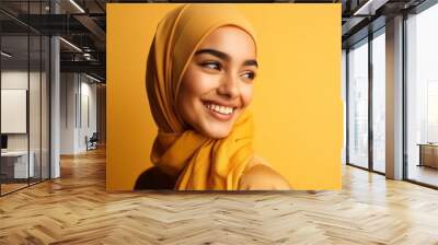 Smiling happy arab asian muslim woman in yellow hijab clothes isolated on yellow background studio portrait. Uae people middle east islam religious concept. generative AI Wall mural